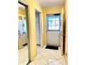 Bright entryway with tile flooring and access to a coat closet at 1660 S Lake Ave # 1, Clearwater, FL 33756