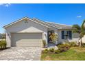 Attractive single-story home featuring a two car garage and well landscaped yard at 17901 Solstice Ave, Venice, FL 34293