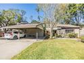 Covered carport with parking for one car and additional bike storage at 215 Woods Landing Trl, Oldsmar, FL 34677
