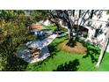 Lush backyard oasis featuring a pool, tennis court, and patio at 4518 W Rosemere Rd, Tampa, FL 33609