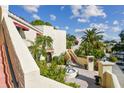 Condo building exterior with lush landscaping and fountain at 6101 34Th W St # 29C, Bradenton, FL 34210