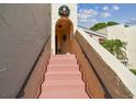 Pink painted stairs leading to condo entrance at 6101 34Th W St # 29C, Bradenton, FL 34210