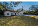 House exterior showcasing a large yard and driveway at 9800 Mendel Dr, New Port Richey, FL 34654