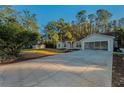 Exterior view of the house, showcasing the front yard and driveway at 9800 Mendel Dr, New Port Richey, FL 34654