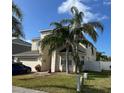 Charming two-story home with palm trees and landscaping in front yard at 1449 Kaffir Lily Ct, Trinity, FL 34655