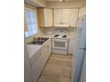 Efficient kitchen featuring white appliances and wood-look floors at 203 47Th Avenue W Dr # 167, Bradenton, FL 34207