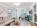Bright living room with a sofa, workspace, and teal armchair at 2483 13Th N Ave, St Petersburg, FL 33713