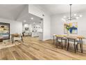 Bright dining room with modern light fixture and wood dining table at 2709 Falling Leaves Dr, Valrico, FL 33596