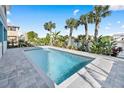 Inviting rectangular pool with light gray pavers and tropical landscaping at 3270 Hibiscus Dr, Hernando Beach, FL 34607