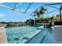 Inviting screened pool with lake view and comfortable seating at 5205 Covesound Way, Apollo Beach, FL 33572