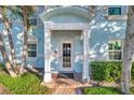 Inviting light blue building exterior, featuring a covered entryway and lush landscaping at 5218 Beach Se Dr # D, St Petersburg, FL 33705