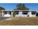 Front view of a freshly painted gray house with awnings at 10273 109Th Ave, Largo, FL 33773