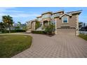 Grand two-story home with circular driveway and landscaped yard at 119 8Th E St, Tierra Verde, FL 33715