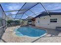 Inviting kidney-shaped pool with a screened enclosure at 12698 116Th St, Largo, FL 33778