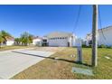 House exterior showcasing a spacious driveway and well-maintained lawn at 545 Lillian Dr, Madeira Beach, FL 33708