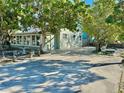 Well-maintained house with a large paved driveway and lush landscaping at 5626 28Th S Ave, Gulfport, FL 33707
