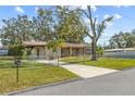 Ranch-style home with a covered carport and a spacious lawn at 8607 Ruth Pl, Tampa, FL 33604