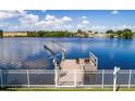Private dock with boat lift and seating area at 8800 Sunlit Cove Ne Dr, St Petersburg, FL 33702