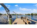 Wooden dock with boat lift overlooking calm water at 8800 Sunlit Cove Ne Dr, St Petersburg, FL 33702