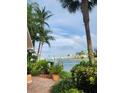 Scenic waterfront view featuring a vibrant rainbow, lush landscaping, and inviting community amenities at 1285 79Th St S, St Petersburg, FL 33707