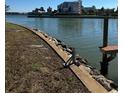 Picturesque waterfront view showing the canal edge with seawall and wooden dock and calm waters at 1285 79Th St S, St Petersburg, FL 33707