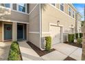 Townhome entry with teal door and walkway at 17827 Althea Blue Pl, Lutz, FL 33558