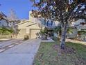 Two-story townhome with two-car garage and landscaped front yard at 3125 Royal Tuscan Ln, Valrico, FL 33594