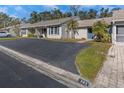 Exterior view of condo building, showing parking and landscaping at 381 Estero Ct, Safety Harbor, FL 34695