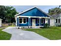 Newly constructed home with blue siding and a small front yard at 4202 N 15Th St, Tampa, FL 33610