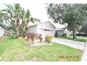 Front view of a two-story house with a garage and landscaping at 504 Maple Pointe Dr, Seffner, FL 33584