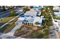 Aerial view of a light blue house with a damaged roof at 5735 31St S Ave, Gulfport, FL 33707