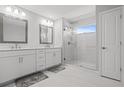 Double vanity bathroom with a large walk in shower at 5805 Grand Sonata Ave, Lutz, FL 33558