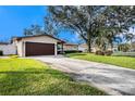 House exterior showcasing a large driveway and lush lawn at 5857 25Th S St, St Petersburg, FL 33712