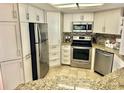 Updated kitchen, featuring stainless steel appliances and granite countertops at 9790 66Th N St # 428, Pinellas Park, FL 33782