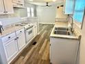 Renovated kitchen with white cabinets, granite counters, and stainless steel appliances at 9790 66Th N St # 74, Pinellas Park, FL 33782