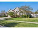 Landscaped yard surrounds this charming one-story house with a two-car garage at 1202 Shotona Ct, Brandon, FL 33511