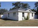 Side view of the house showcasing its clean lines and curb appeal at 1302 E Annie St, Tampa, FL 33612