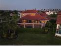 Aerial view of the back of a home with a screened-in pool and lush landscaping at 1414 Alhambra Dr, Apollo Beach, FL 33572