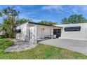 Mid-century modern home with carport and updated facade at 402 161St Ave, Redington Beach, FL 33708