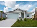 Single story home with light green garage door and neatly landscaped lawn at 475 Winwood Ct, Port Charlotte, FL 33954