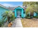 Elegant entryway featuring a covered porch and double doors at 6149 Canopy Oaks Ct, New Port Richey, FL 34653