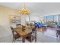 Open-concept dining room featuring a chandelier and an adjacent living room at 6287 Bahia Del Mar Cir # 603, St Petersburg, FL 33715