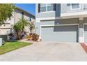 View of a three-car garage and landscaping at 8423 Blue Rock Dr, New Port Richey, FL 34653