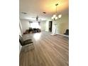 Spacious living room featuring gray vinyl flooring and lots of natural light at 11253 Leland St, Spring Hill, FL 34609