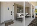 Covered porch with stylish seating and a modern door at 2085 Georgianna St, Largo, FL 33774