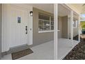 Covered porch with modern door and view of window at 2085 Georgianna St, Largo, FL 33774