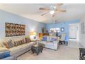 Living room with light beige couch and view to dining area and kitchen at 2400 Winding Creek Blvd # 24-203, Clearwater, FL 33761