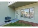 Ground level condo entrance with a bench and landscaping at 2447 Ecuadorian Way # 1, Clearwater, FL 33763