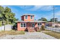 Front exterior of a two-story home with a driveway and small yard at 3306 N Howard Ave, Tampa, FL 33607