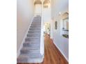 Staircase with carpet and hardwood floors in the hallway at 25028 Hyde Park Blvd, Land O Lakes, FL 34639